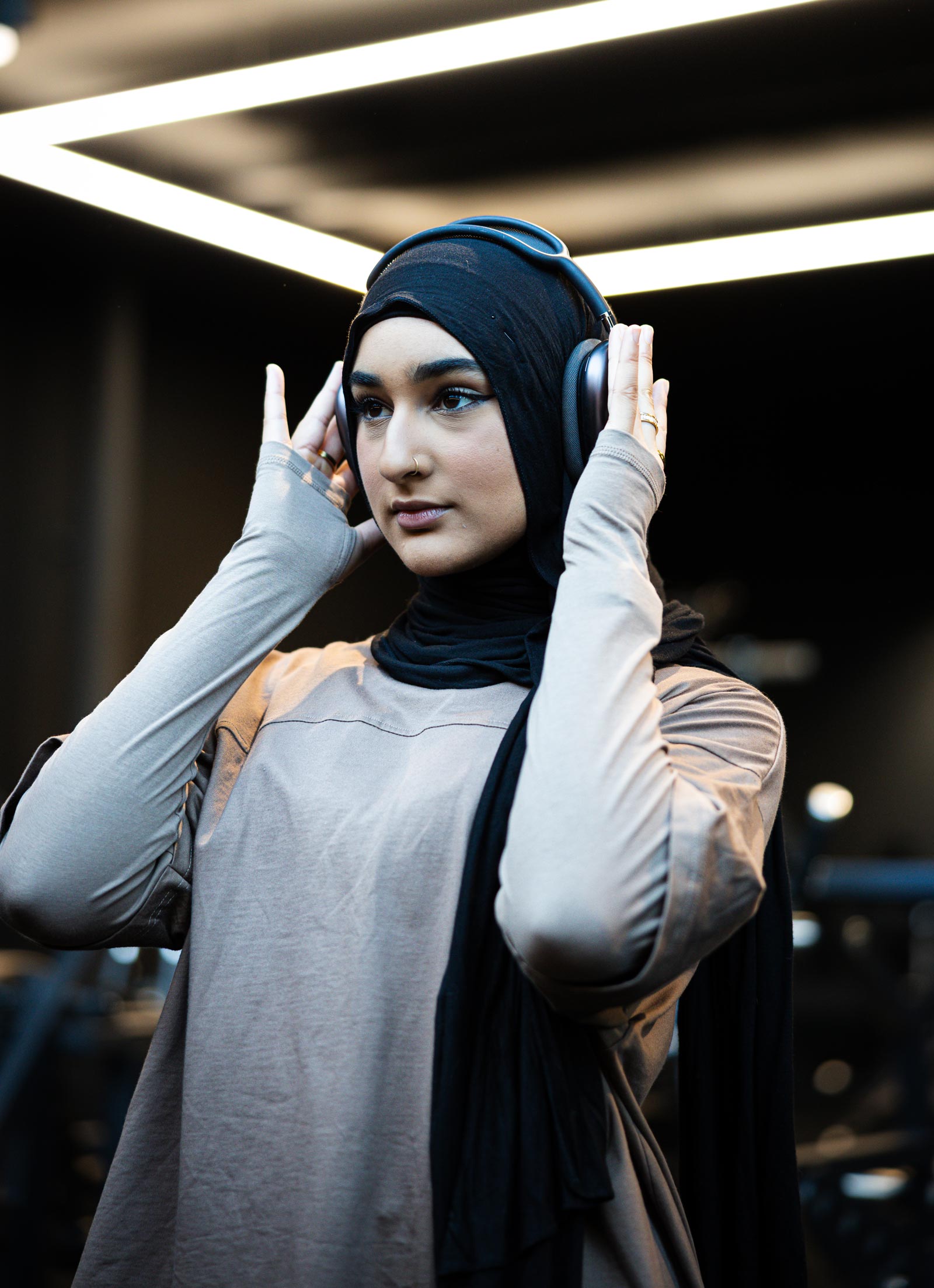 Coach setting headphone in the gym